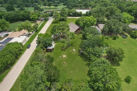 an aerial view of residential houses with outdoor space and street view
