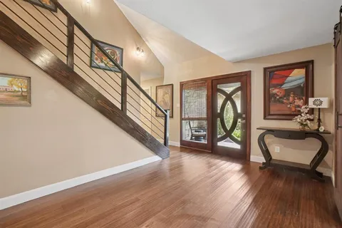 a view of front door with porch and wooden floor
