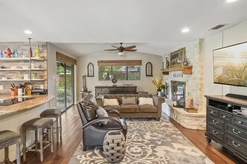 a living room with fireplace furniture and a flat screen tv