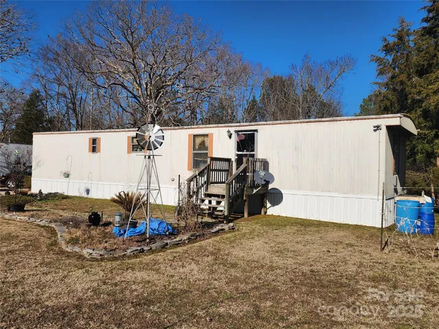 a view of a house with a yard covered with snow in front of house