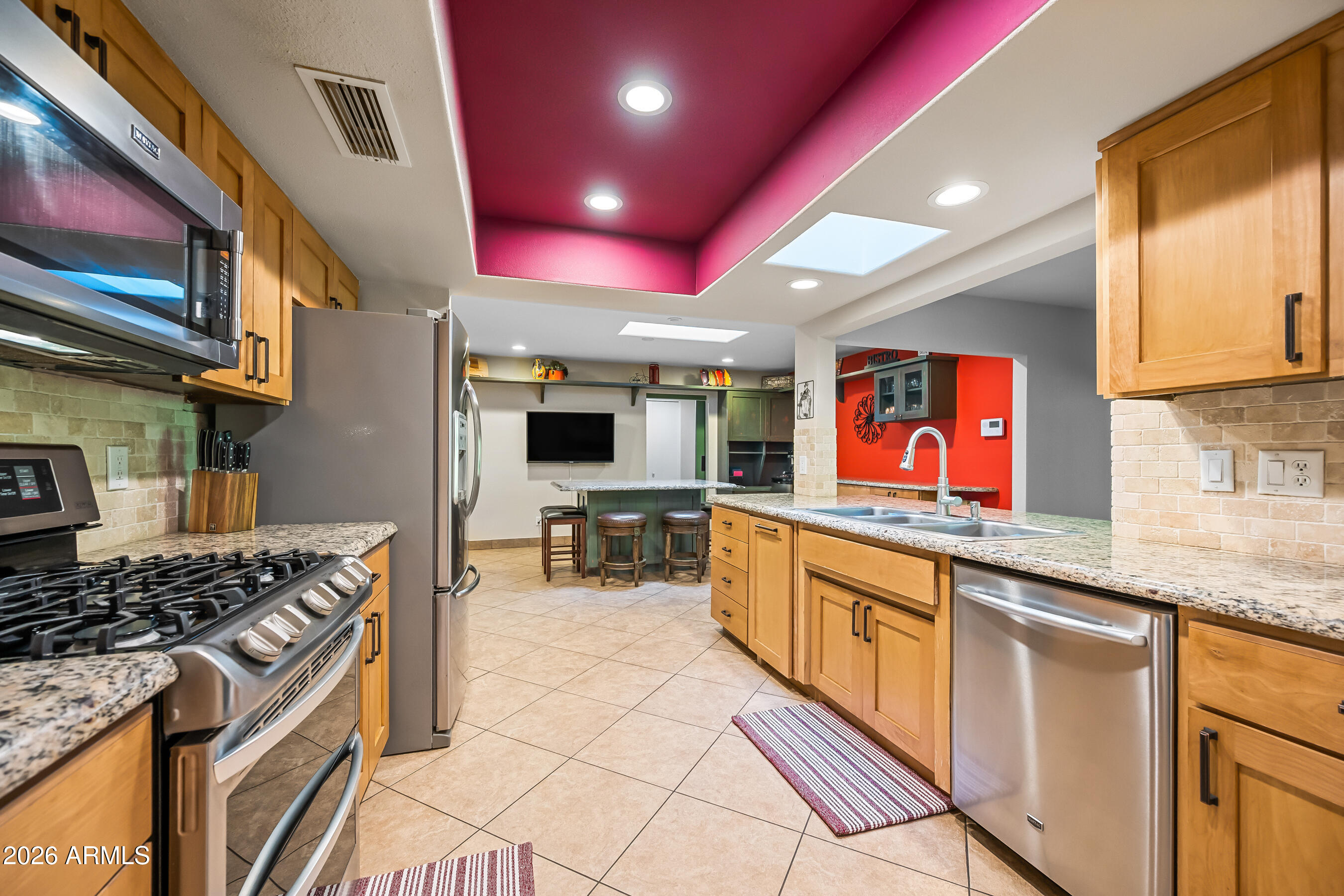 5802 South Stanley Place Tempe, AZ 85283 - Photo 11 of 50 a kitchen with stainless steel appliances granite countertop a stove a sink and a microwave
