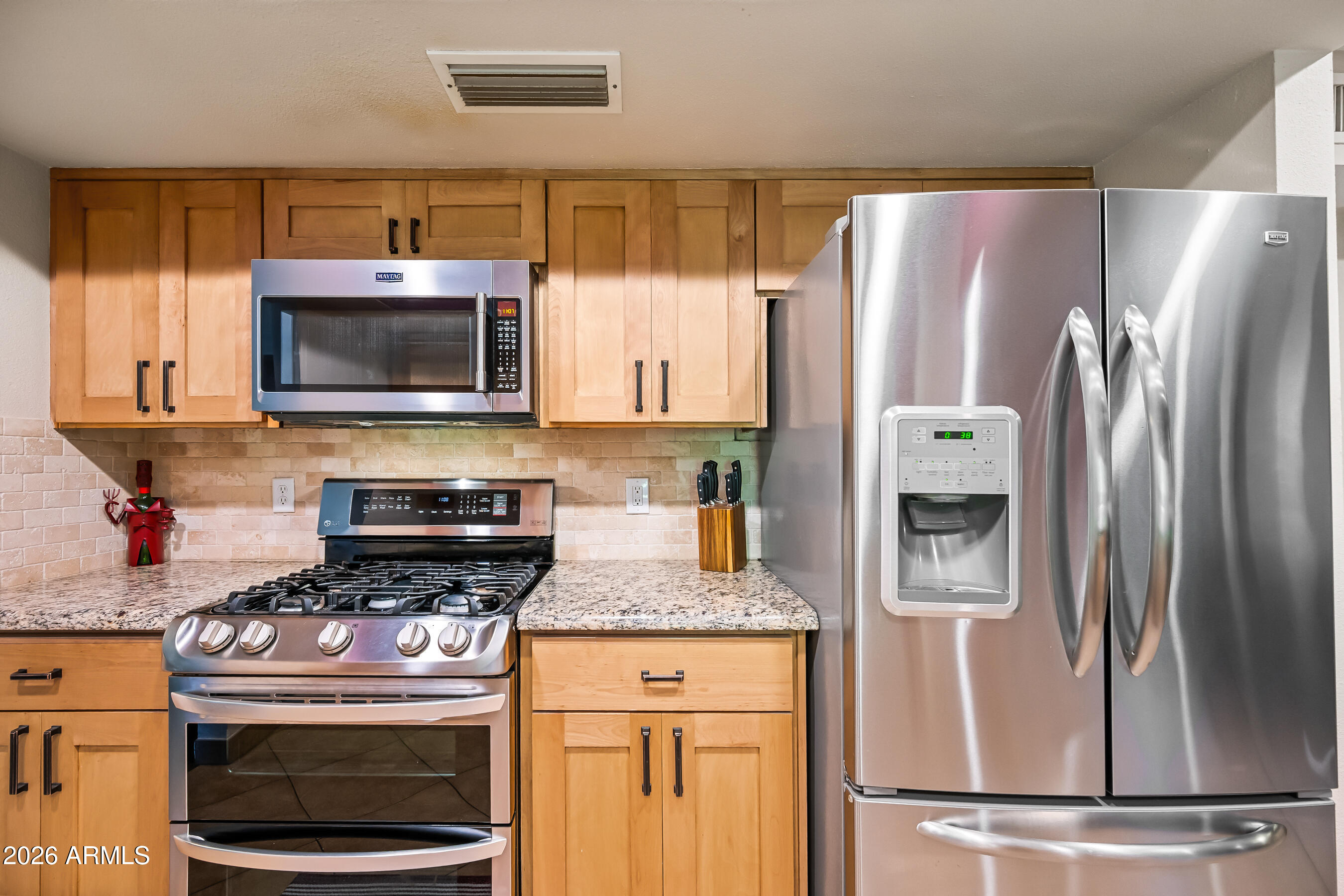 5802 South Stanley Place Tempe, AZ 85283 - Photo 13 of 50 a kitchen with granite countertop a refrigerator stove and microwave