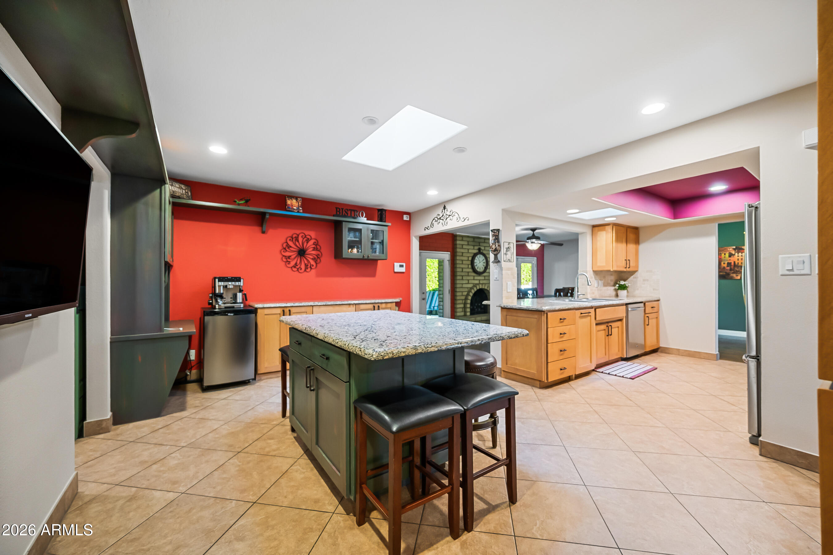 5802 South Stanley Place Tempe, AZ 85283 - Photo 16 of 50 a kitchen with stainless steel appliances kitchen island granite countertop a table and chairs in it