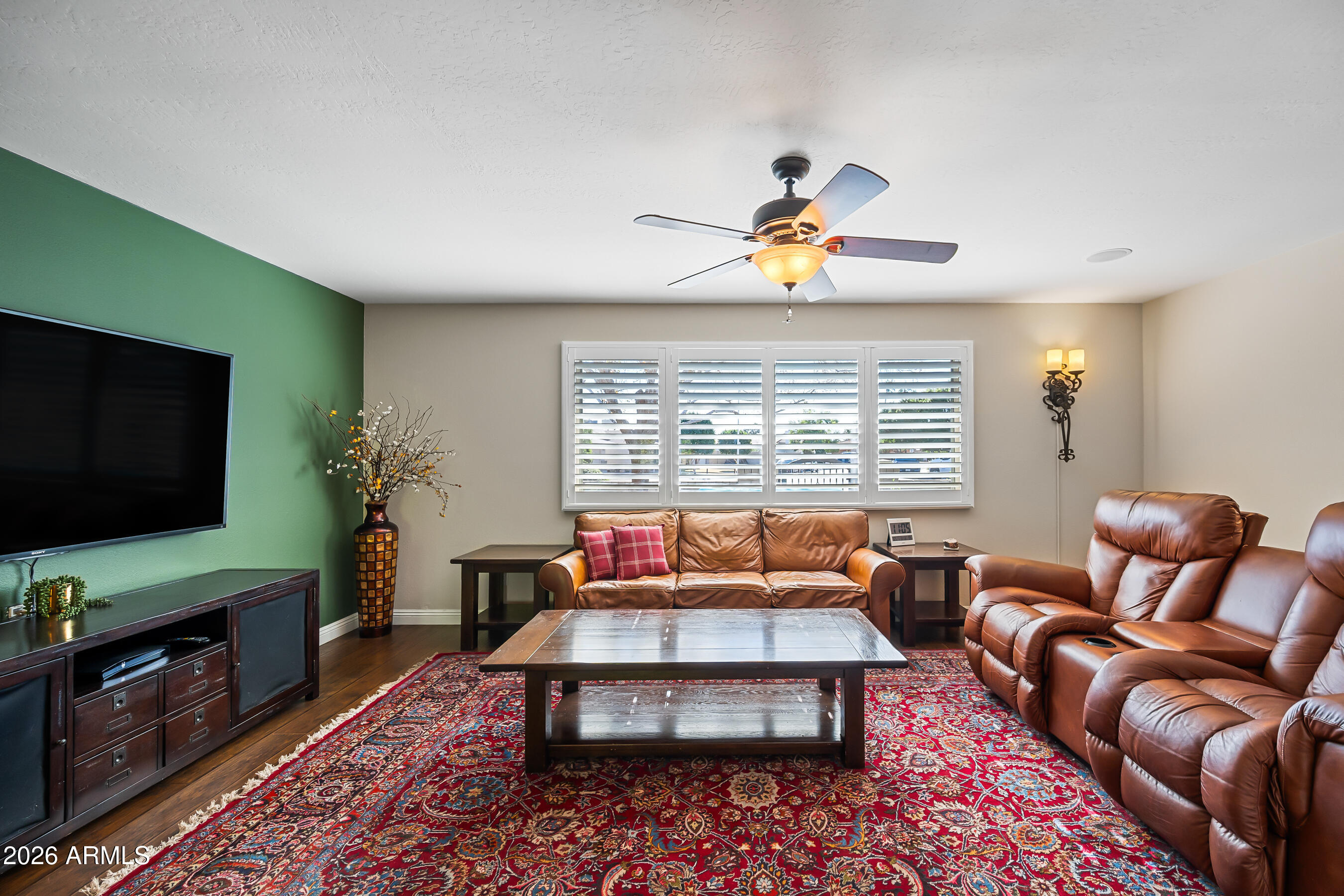 5802 South Stanley Place Tempe, AZ 85283 - Photo 9 of 50 a living room with furniture a flat screen tv and wooden floor