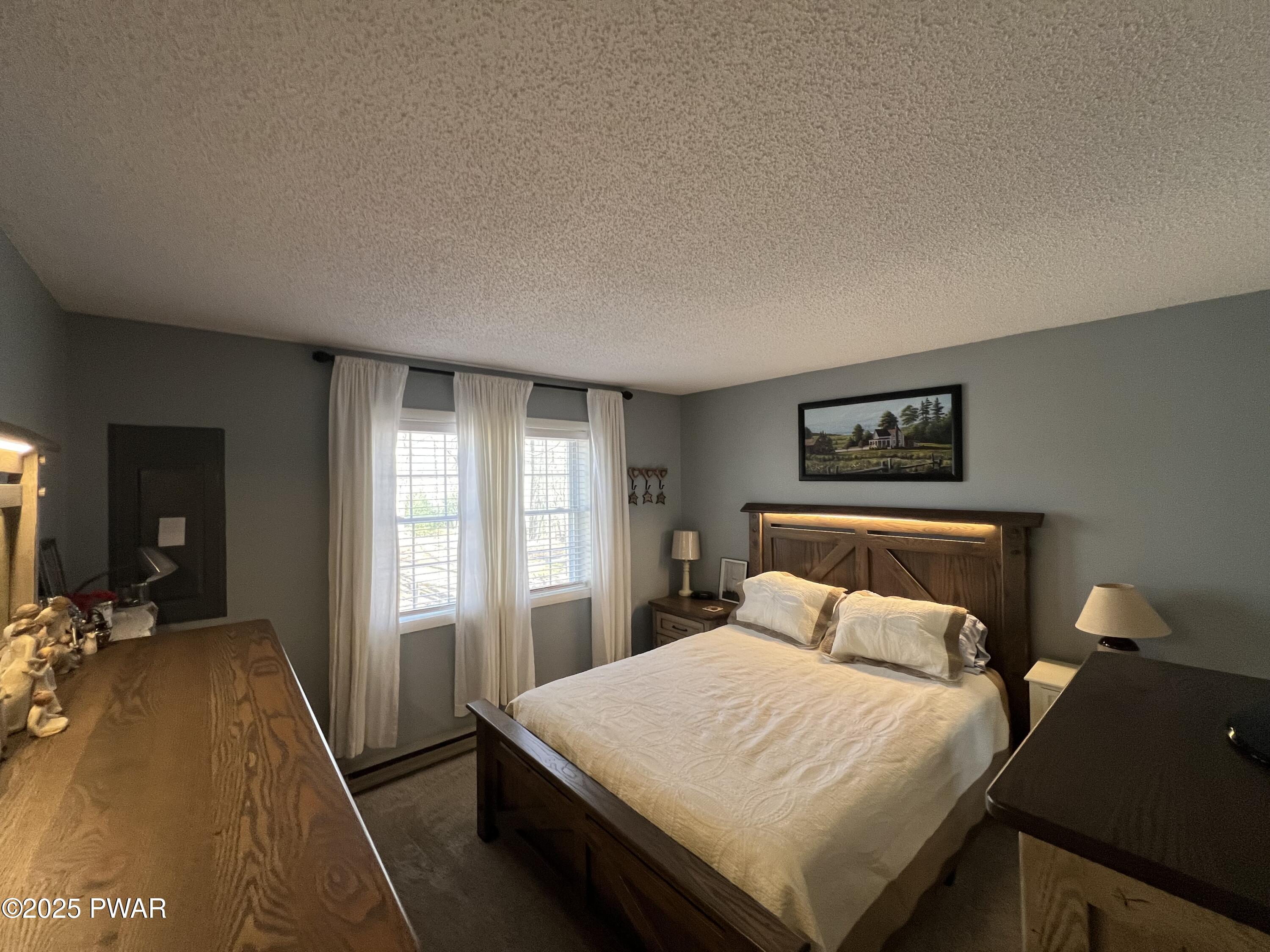 119 Rodeo Drive Hawley, PA 18428 - Photo 18 of 34 a bedroom with a bed and a lamp with window