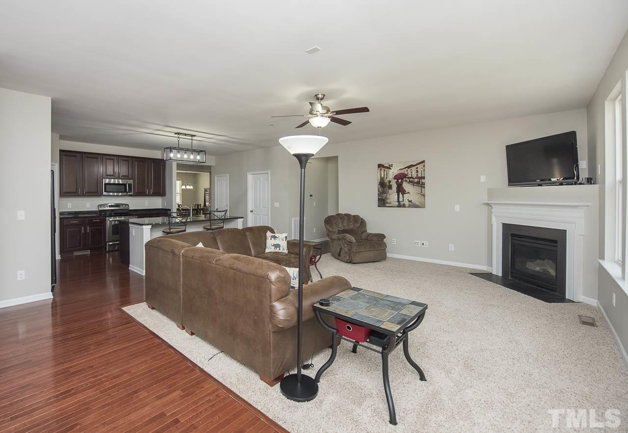 1136 Farmers Branch Road Willow Spring, NC 27592 - Photo 11 of 30 a living room with furniture a flat screen tv and kitchen view