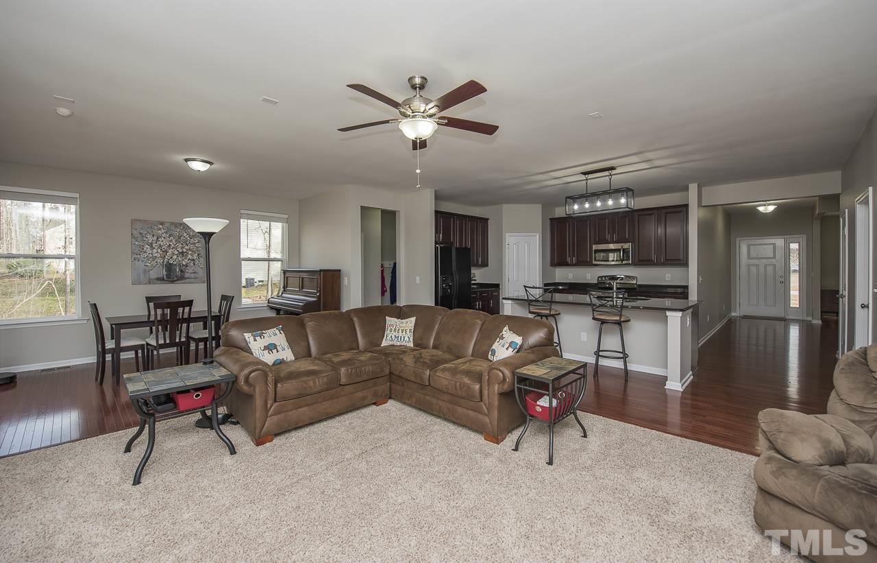 1136 Farmers Branch Road Willow Spring, NC 27592 - Photo 13 of 30 a living room with furniture and kitchen view
