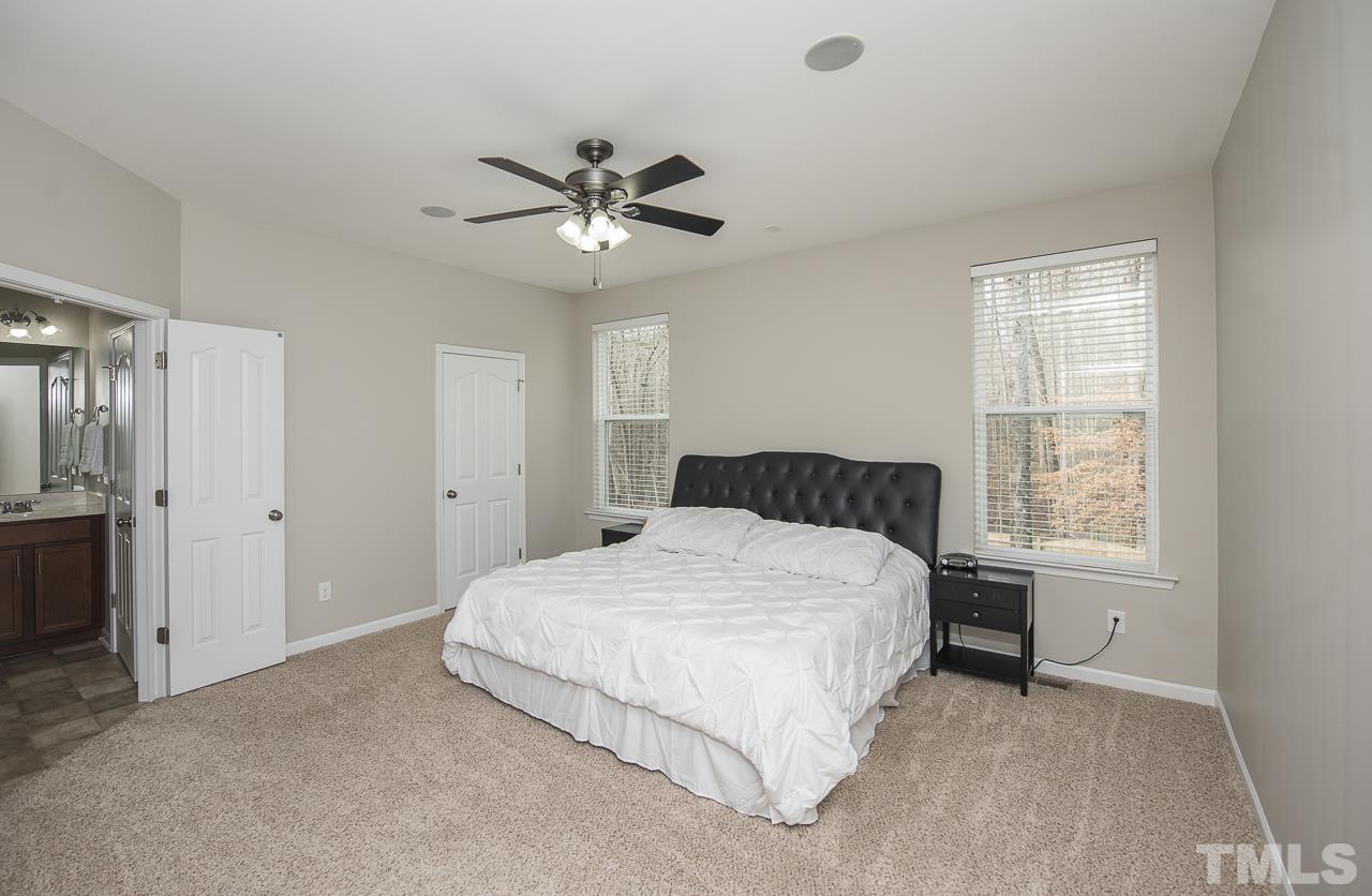 1136 Farmers Branch Road Willow Spring, NC 27592 - Photo 14 of 30 a bedroom with a bed and a window