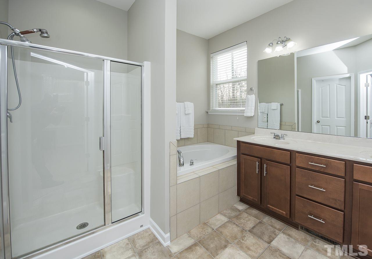 1136 Farmers Branch Road Willow Spring, NC 27592 - Photo 15 of 30 a bathroom with a tub a sink and mirrors
