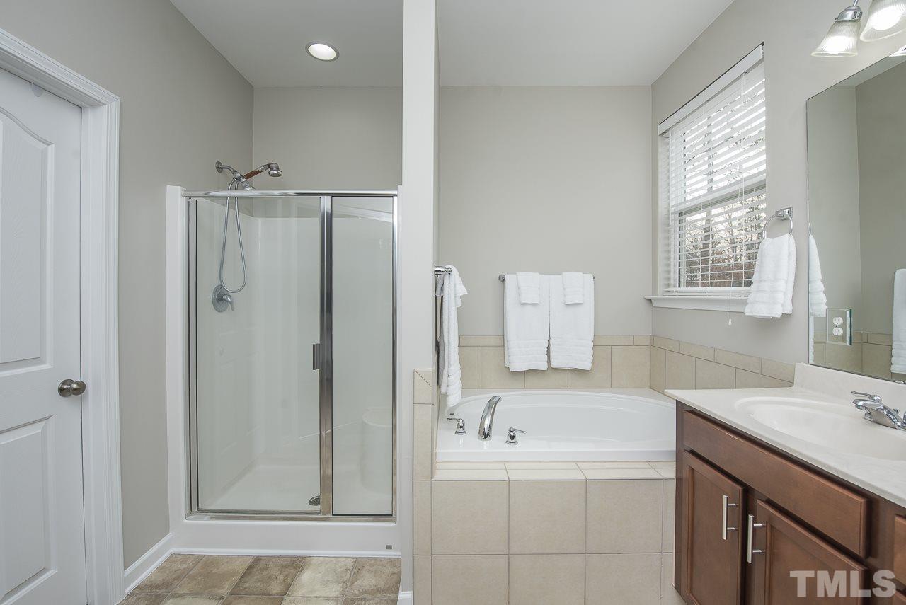 1136 Farmers Branch Road Willow Spring, NC 27592 - Photo 16 of 30 a bathroom with a tub sink and mirror