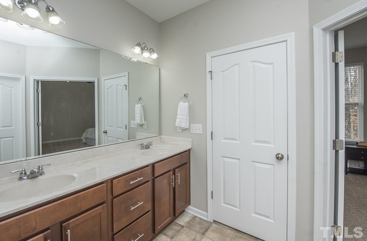 1136 Farmers Branch Road Willow Spring, NC 27592 - Photo 18 of 30 a bathroom with a granite countertop double vanity sink and a mirror