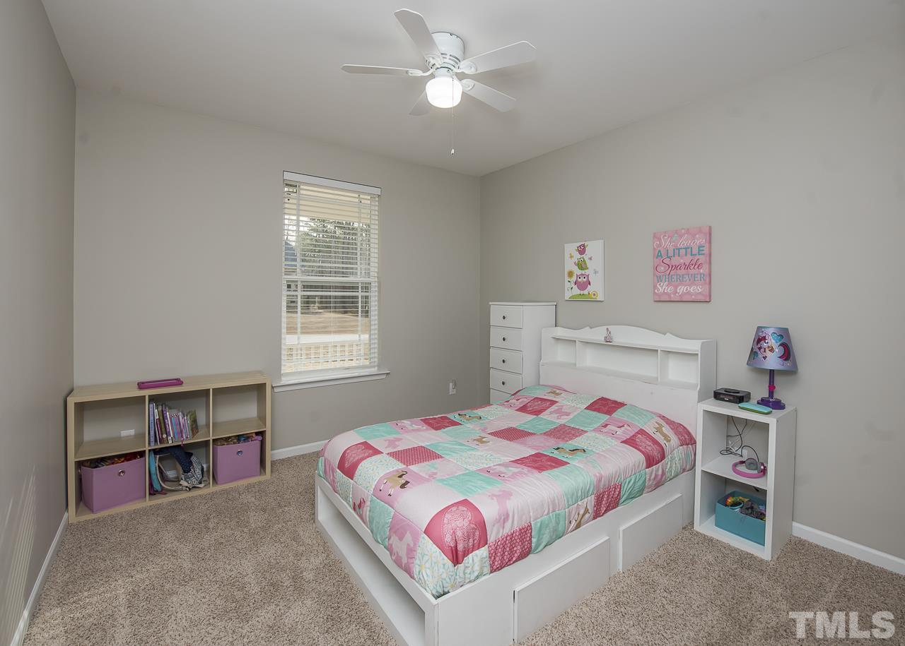 1136 Farmers Branch Road Willow Spring, NC 27592 - Photo 19 of 30 a bedroom with a bed and a book shelf