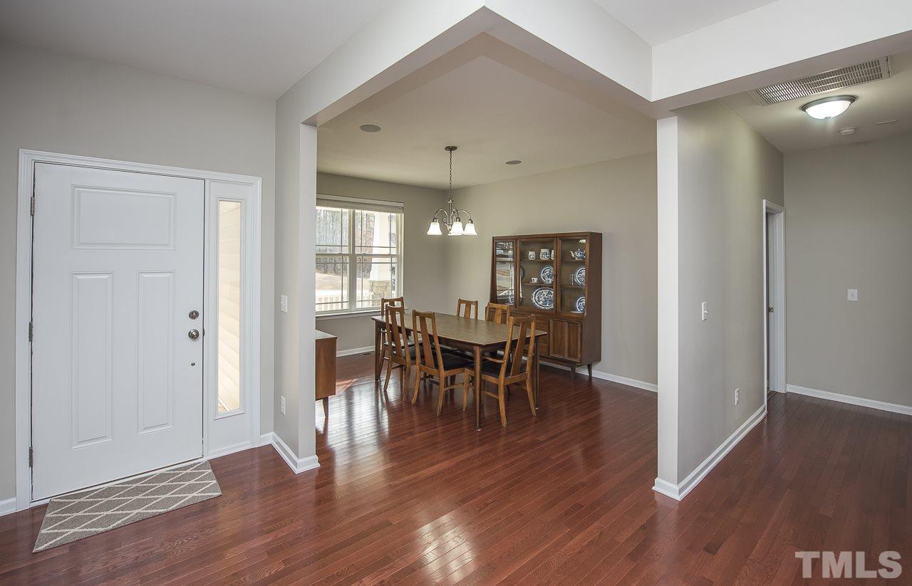1136 Farmers Branch Road Willow Spring, NC 27592 - Photo 3 of 30 a view of a dining room with furniture and wooden floor