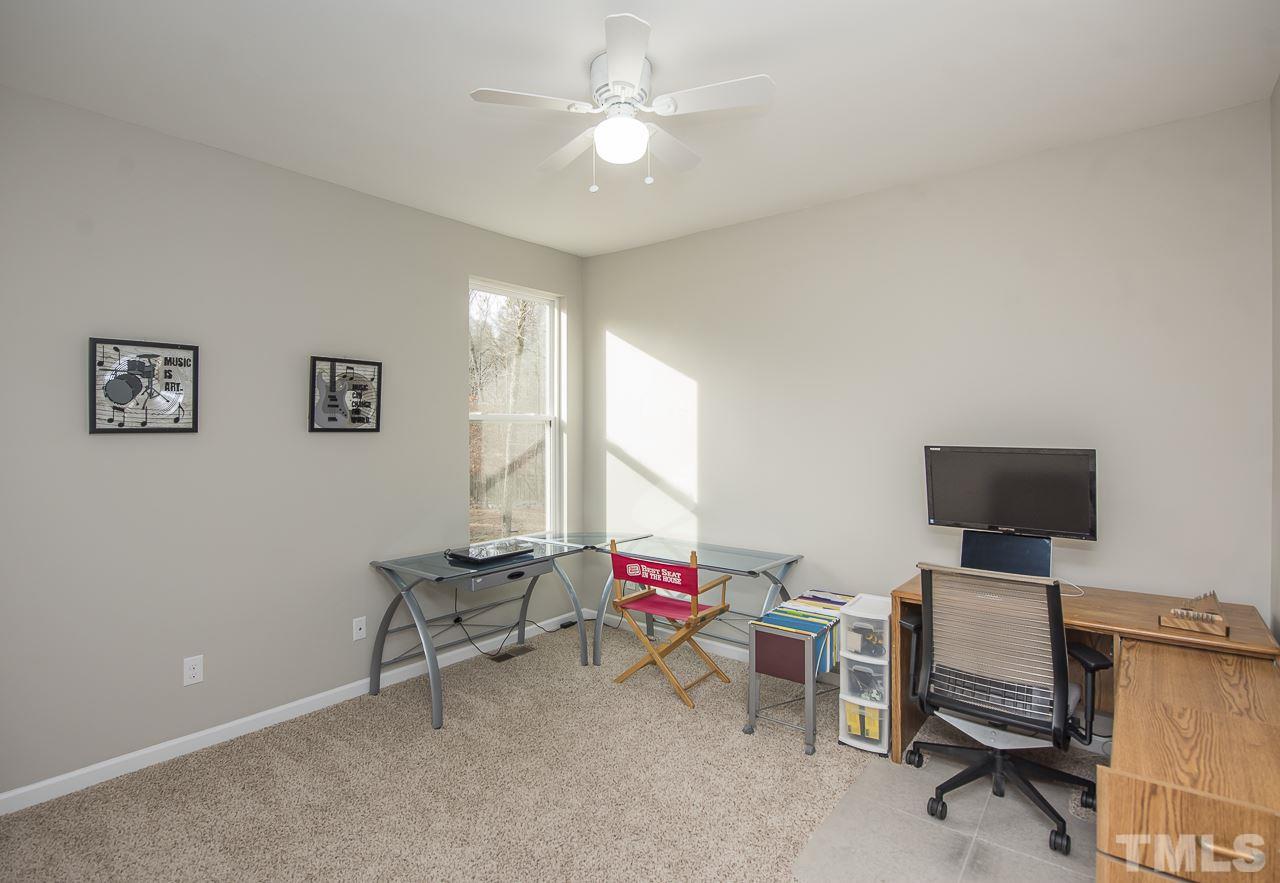 1136 Farmers Branch Road Willow Spring, NC 27592 - Photo 22 of 30 a living room with furniture and a flat screen tv
