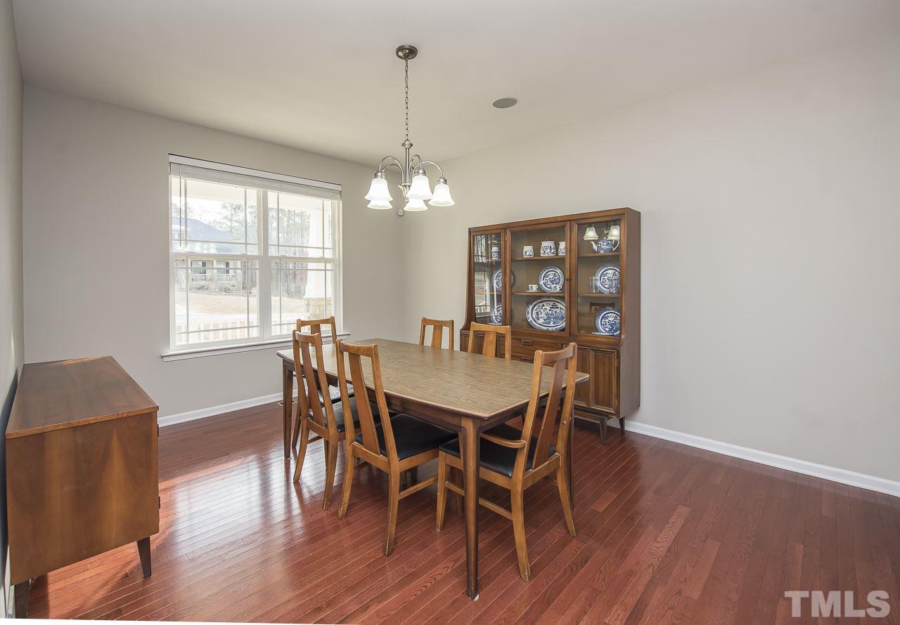 1136 Farmers Branch Road Willow Spring, NC 27592 - Photo 4 of 30 a view of a dining room with furniture window and wooden floor