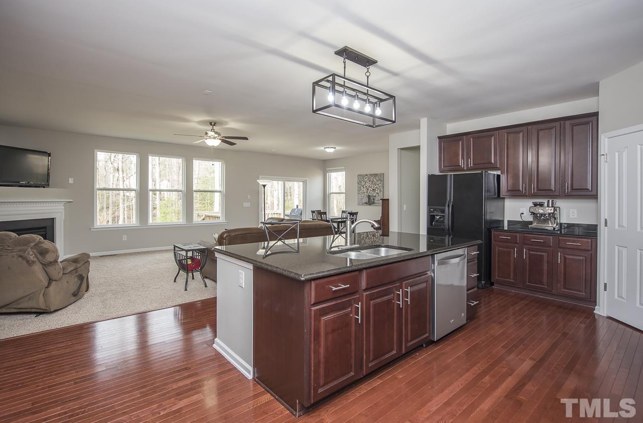 1136 Farmers Branch Road Willow Spring, NC 27592 - Photo 5 of 30 a kitchen with stainless steel appliances granite countertop a stove and a refrigerator
