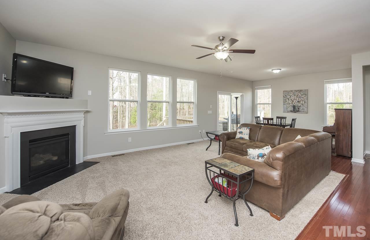 1136 Farmers Branch Road Willow Spring, NC 27592 - Photo 8 of 30 a living room with furniture and a flat screen tv