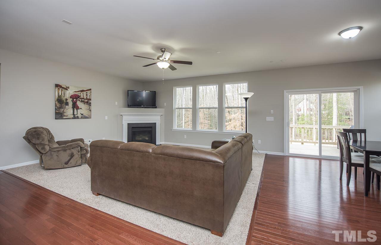 1136 Farmers Branch Road Willow Spring, NC 27592 - Photo 9 of 30 a living room with furniture fireplace and flat screen tv