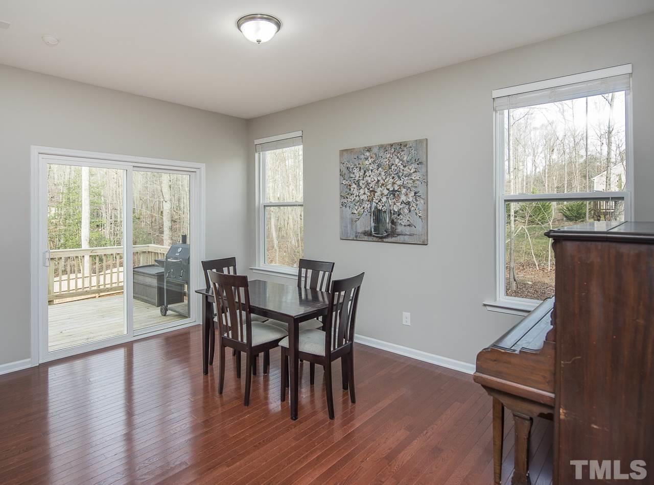 1136 Farmers Branch Road Willow Spring, NC 27592 - Photo 10 of 30 a view of a dining room with furniture and wooden floor