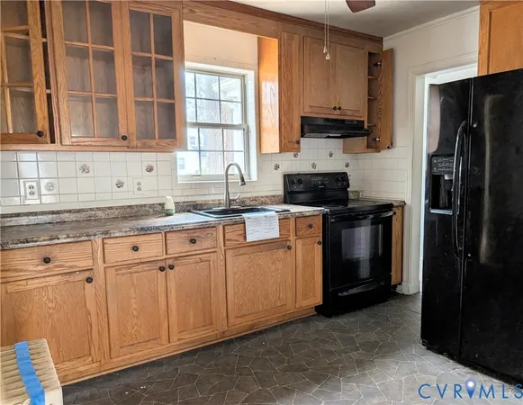 a kitchen with granite countertop white cabinets stainless steel appliances and a sink