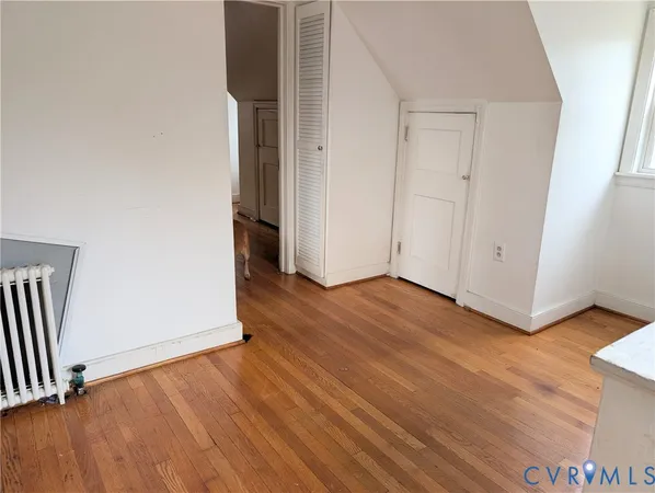 an empty room with wooden floor