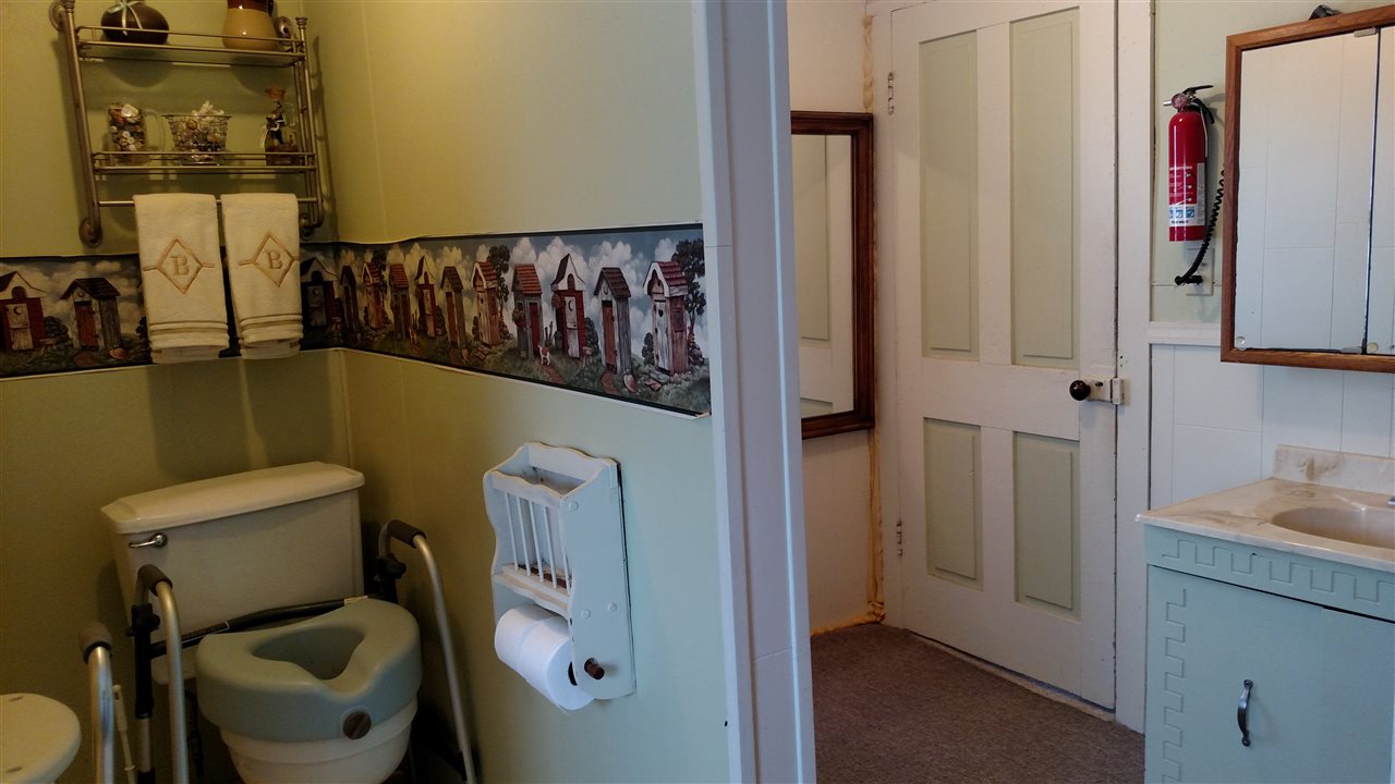 6164 East Flagg Road Ashton, IL 61006 - Photo 17 of 25 a bathroom with a toilet sink and mirror