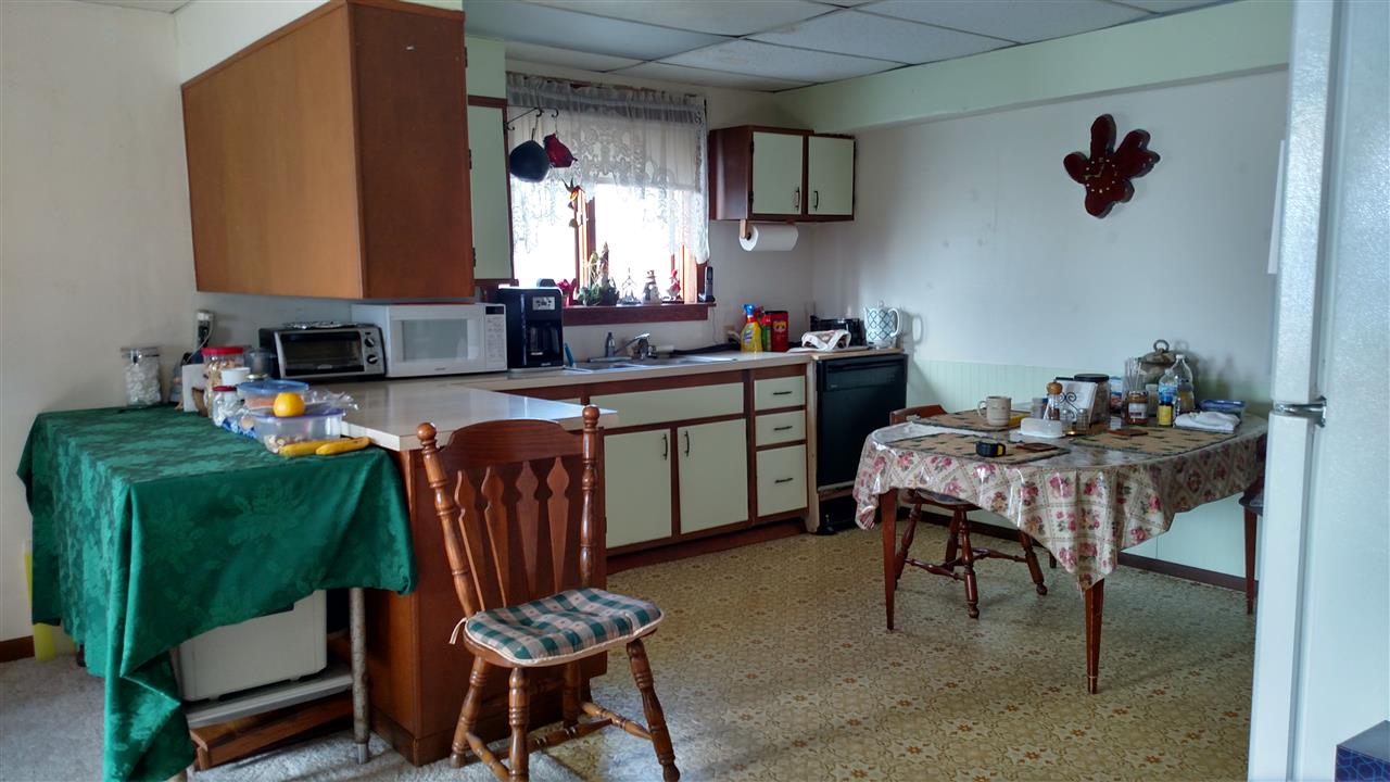 6164 East Flagg Road Ashton, IL 61006 - Photo 6 of 25 a kitchen with a dining table chairs and a refrigerator