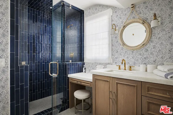 a bedroom with a bed and a window with painted walls