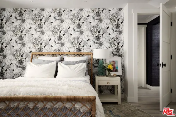 a spacious bathroom with a double vanity sink a toilet a mirror and shower