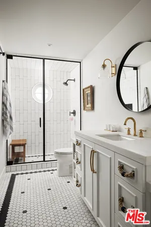 a bathroom with a sink mirror and vanity