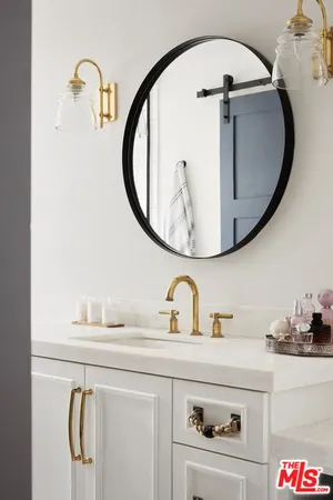 a bedroom with a bed and mirror