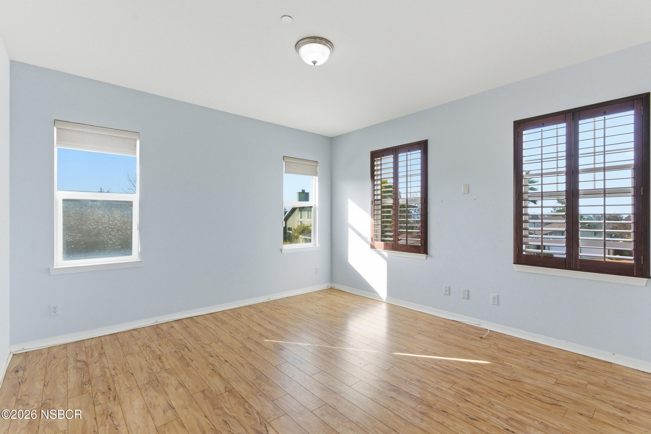 5632 Menemsha Lane Santa Maria, CA 93455 - Photo 35 of 66 a view of an empty room with wooden floor and a window