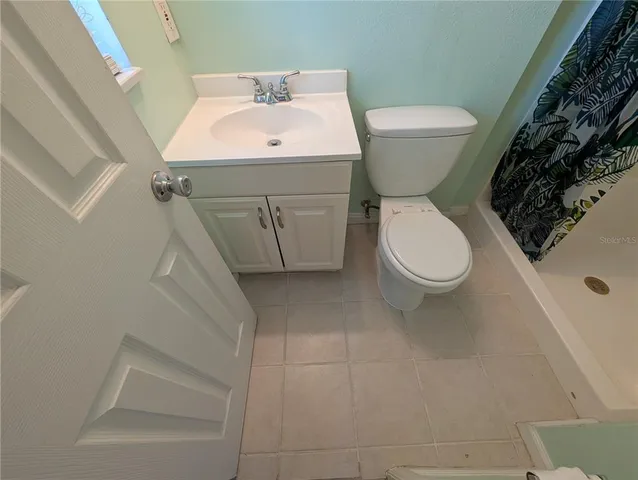 a white toilet sitting next to a bathroom sink