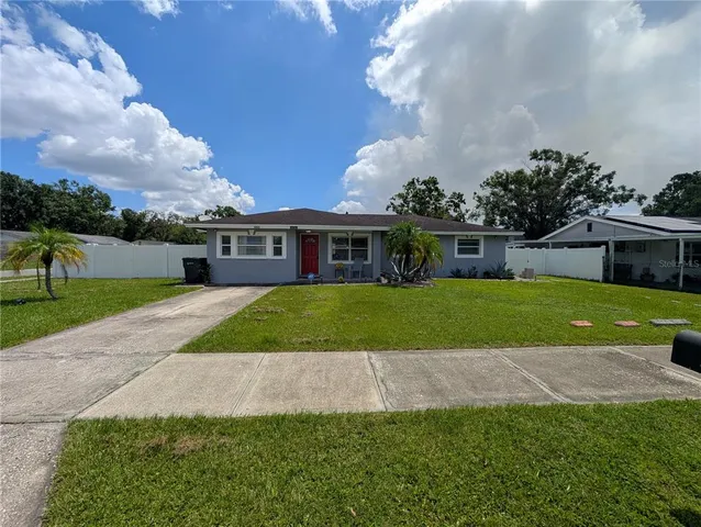 a view of house with a yard