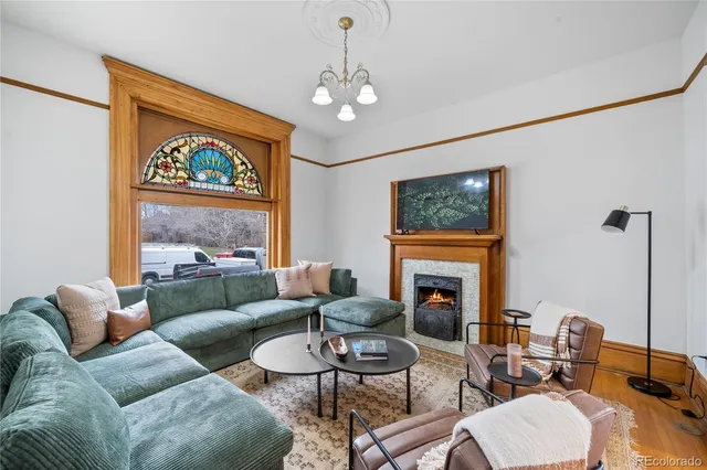 a living room with furniture a fireplace and a flat screen tv