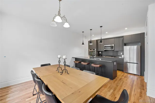 a kitchen with stainless steel appliances kitchen island granite countertop a kitchen island hardwood floor sink and stove