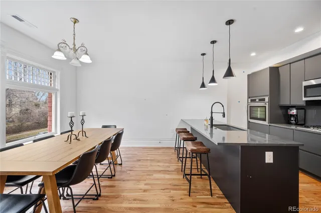 a view of a dining room with furniture wooden floor and a chandelier