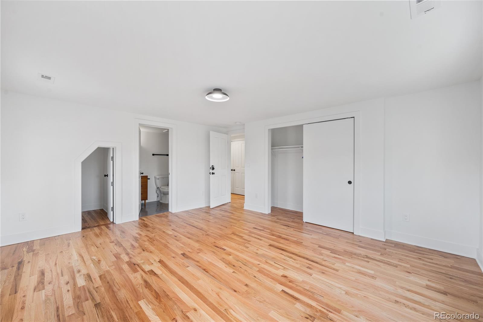 1442-1444 Stuart Street Denver, CO 80204 - Photo 20 of 26 a big room with wooden floor and bathroom in it