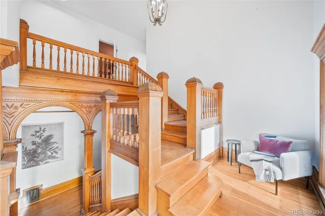 a view of a livingroom with furniture wooden floor and a floor to ceiling window