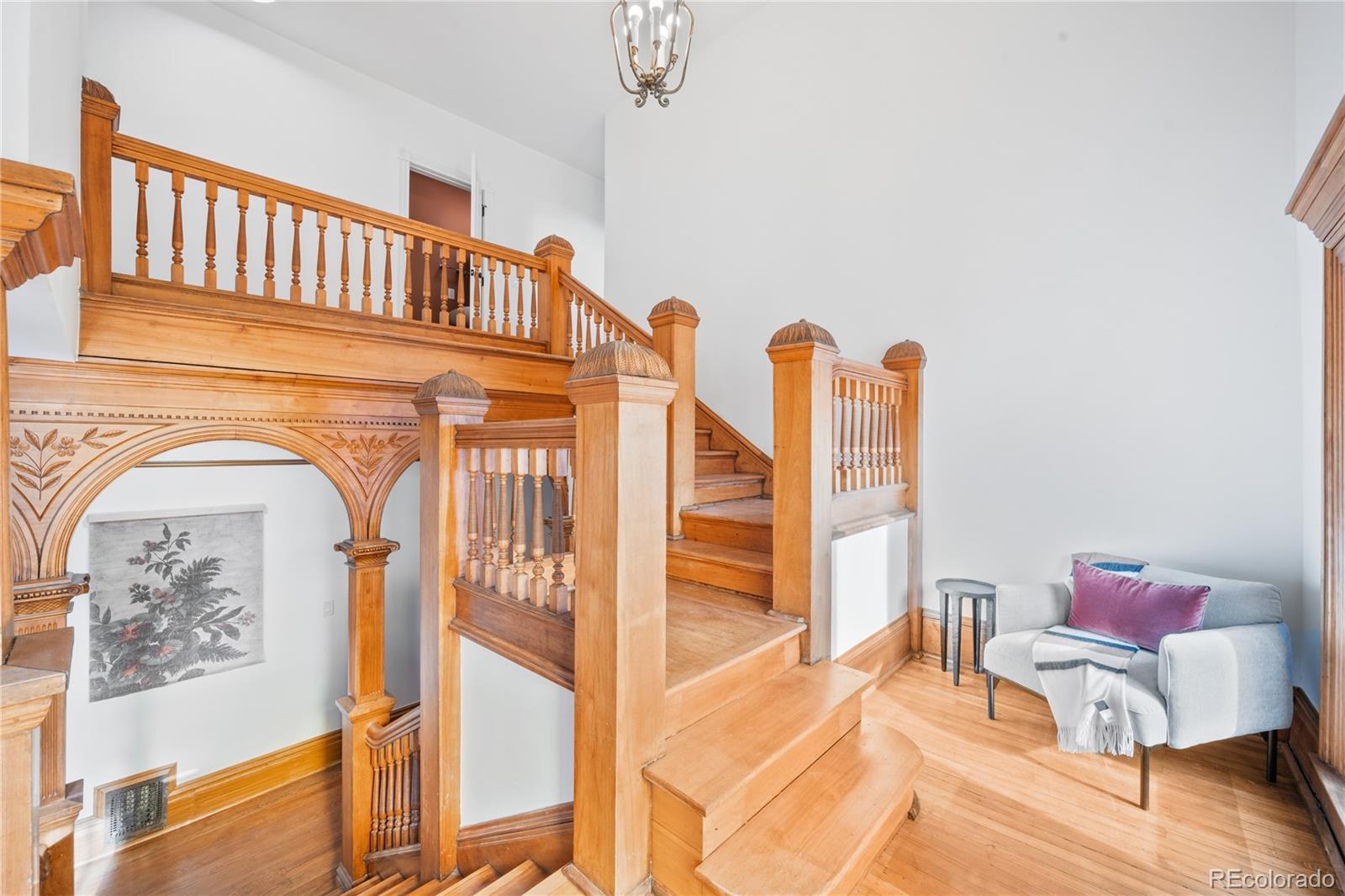1442-1444 Stuart Street Denver, CO 80204 - Photo 5 of 26 a view of a livingroom with furniture wooden floor and a floor to ceiling window