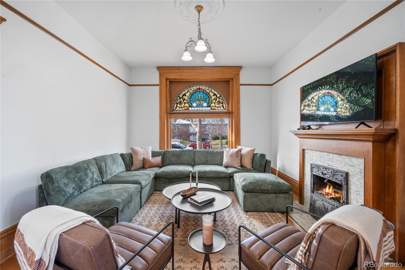 1442-1444 Stuart Street Denver, CO 80204 - Photo 7 of 26 a living room with furniture a flat screen tv and a fireplace