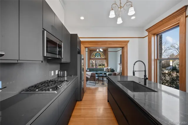 a kitchen with stainless steel appliances a stove sink and cabinets