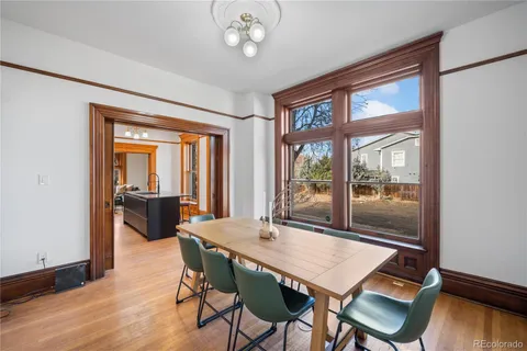 a view of a dining room with furniture window and wooden floor