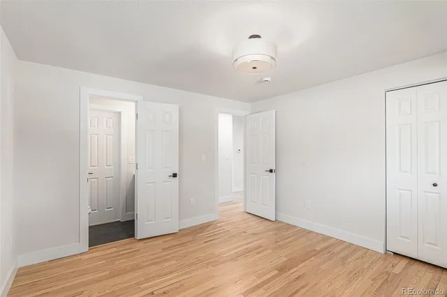 a bathroom with a granite countertop toilet sink and mirror