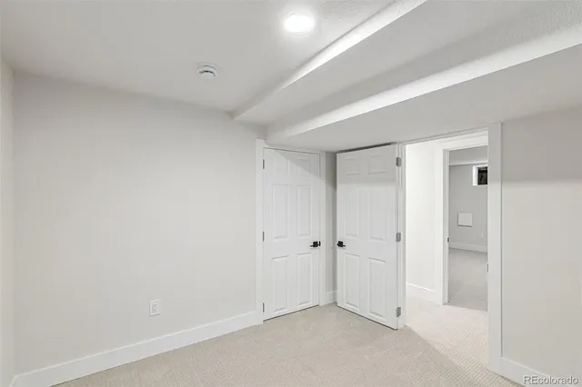 a house is sitting in middle of the green field