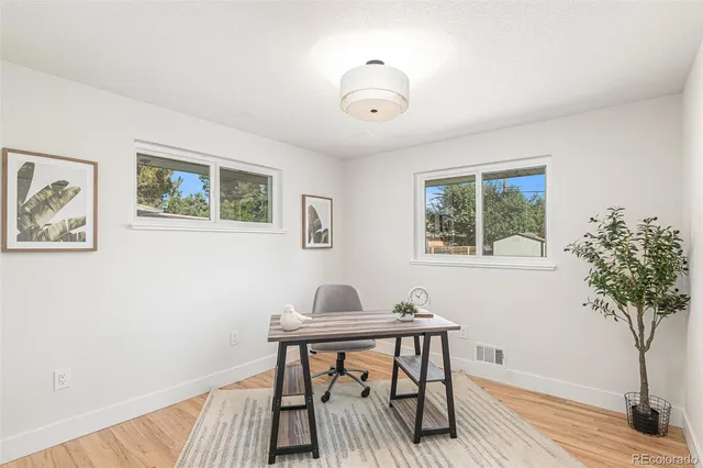 a view of a hallway and wooden floor