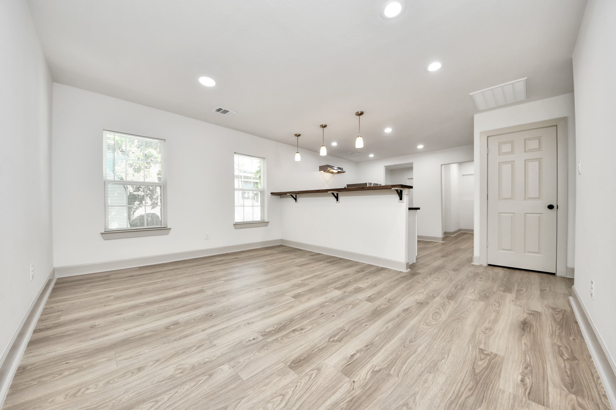 2919 Rosedale Street, Unit B Houston, TX 77004 - Photo 16 of 35 a view of an empty room with wooden floor and a window