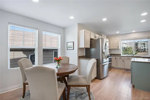 a dining room with furniture a fireplace and wooden floor