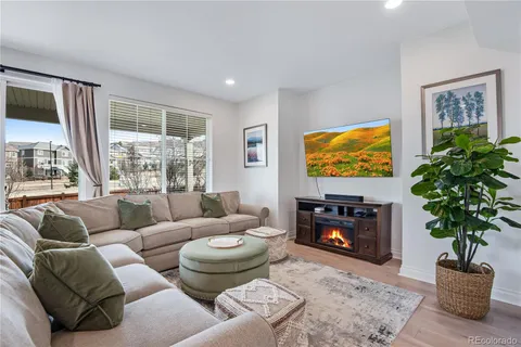 a living room with furniture a potted plant and a fireplace
