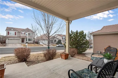a view of backyard with deck and garden